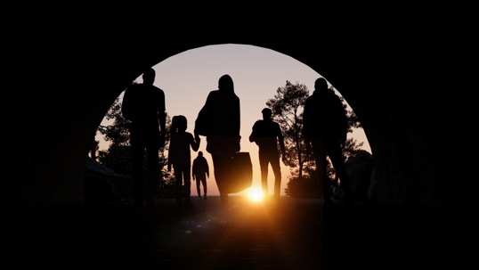 group of immigrants with luggage under a tunnel